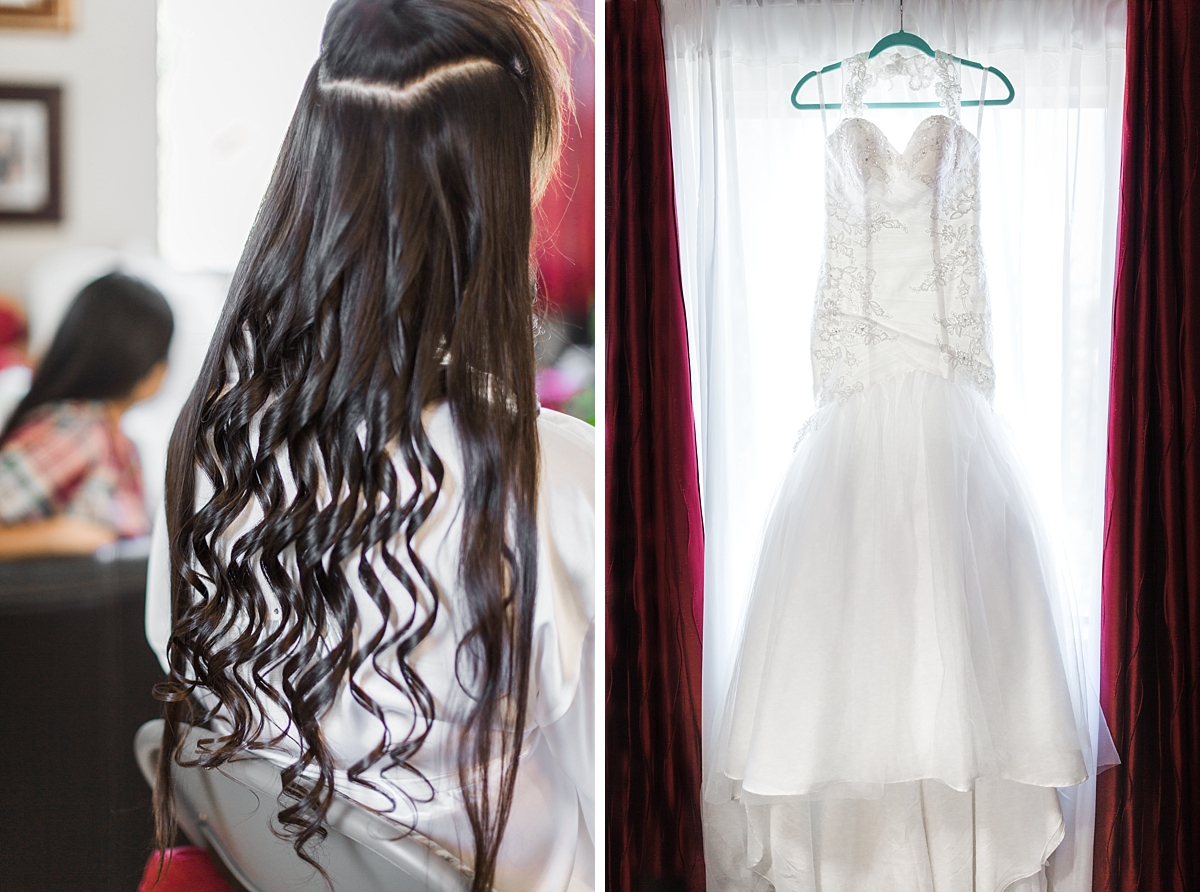 bride getting hair curled and wedding dress