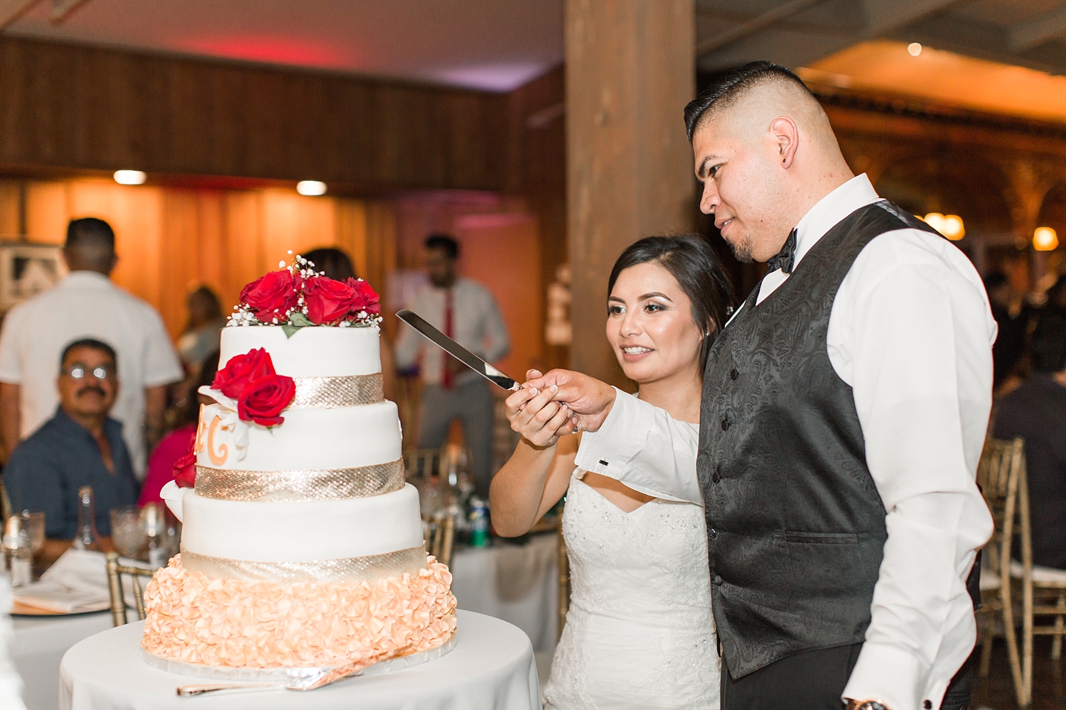 newlyweds cut wedding cake at Heritage Hall