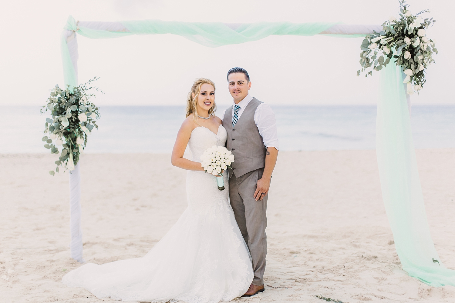 bride and groom on beach in Oasis Cancun wedding