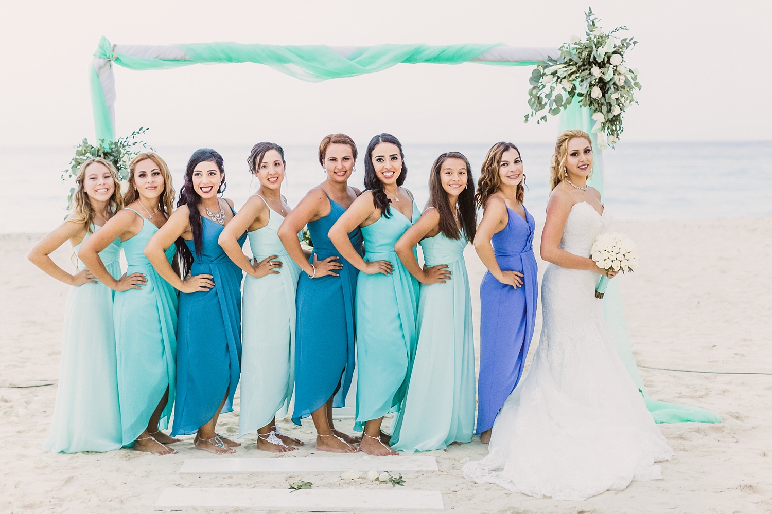 bride and bridesmaids on beach in Oasis Cancun wedding
