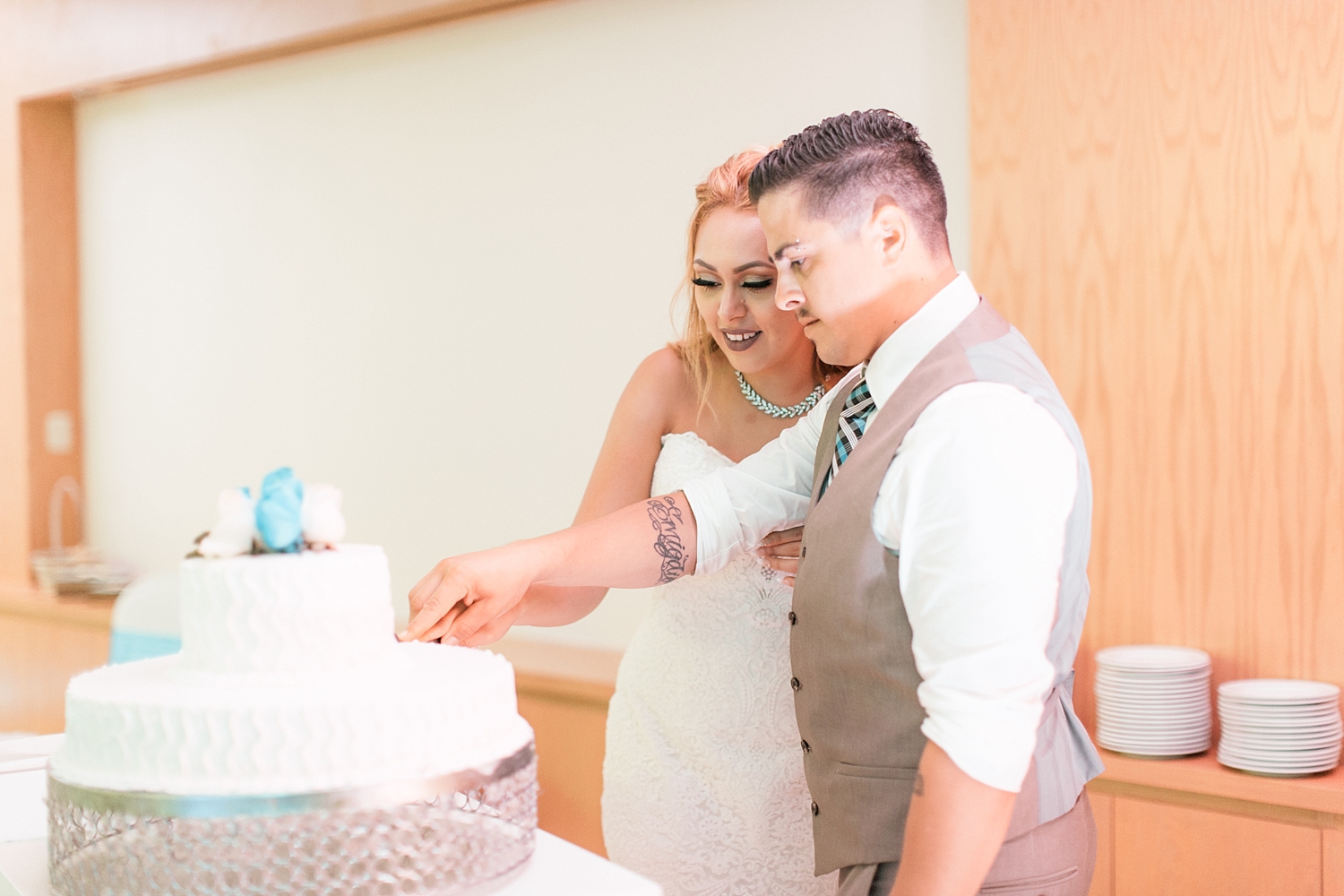 newlyweds cut cake at Oasis Cancun wedding
