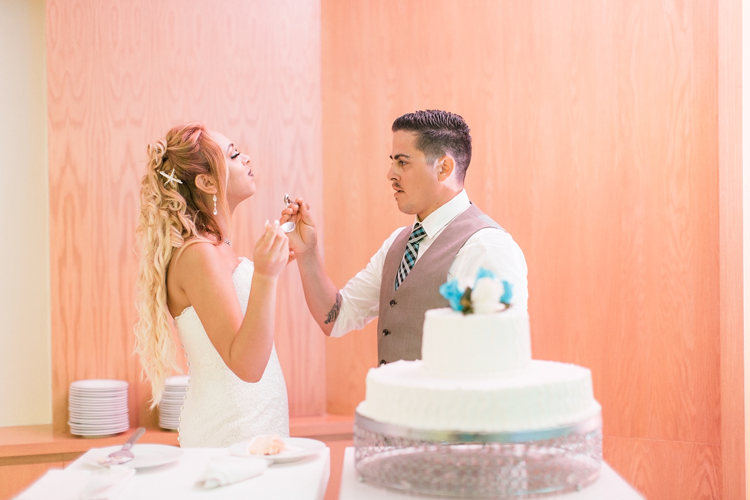 newlyweds cut cake at Oasis Cancun wedding