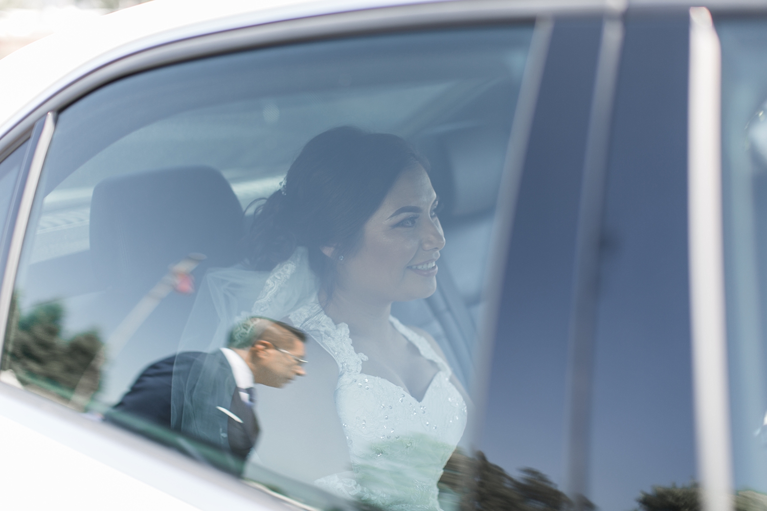 bride smiling through car window